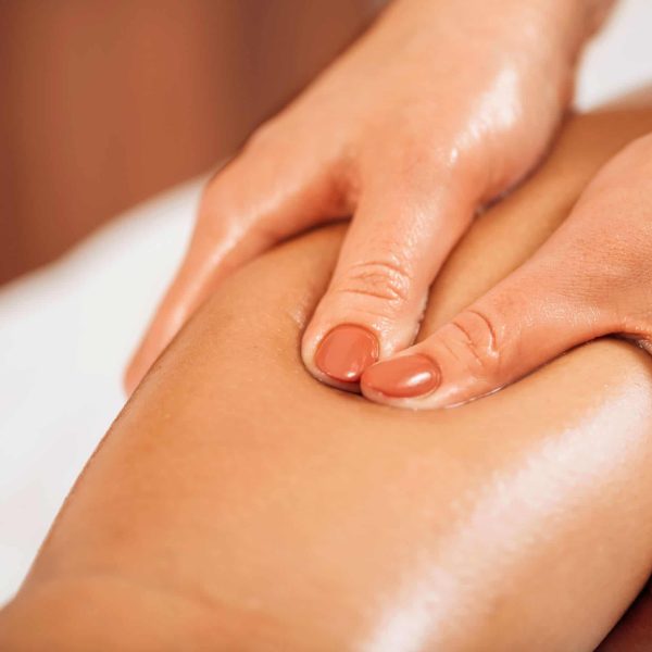 performing a massage for leg pain with oil