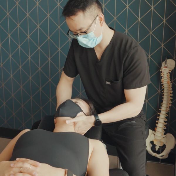 dr. tim treating a woman with neck pain
